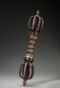 A TIBETAN IRON AND GOLD-INLAID NINE-PRONGED VAJRA