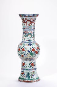 A WUCAI 'DRAGON CHASING PEARL WITH BIRDS AND WAVES' BEAKER VASE