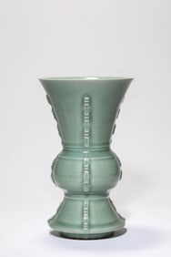 A CELADON BEAKER VASE