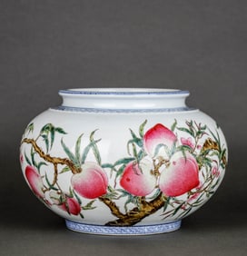 A BLUE AND WHITE BORDERED FAMILLE ROSE 'NINE PEACHES' POMEGRANATE-SHAPED JAR