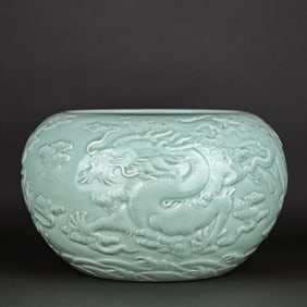 A CELADON-GLAZED CARVED 'DRAGON' APPLE-SHAPED JAR