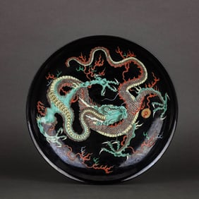A BLACK-GROUND WUCAI 'DRAGON' DISH