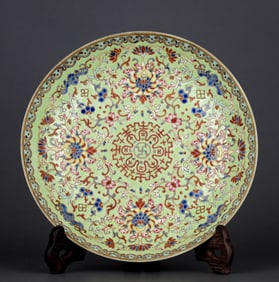 A GREEN-GROUND FAMILLE ROSE 'FLORAL ROUNDELS' DISH