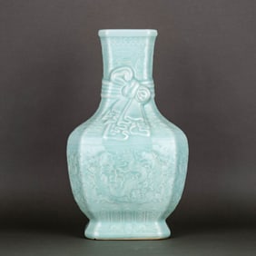 A CELADON-GLAZED CARVED 'CLOUDS, BATS AND DRAGON' VASE