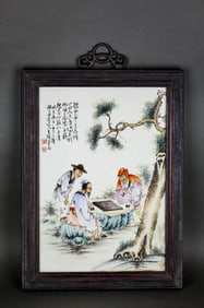 A FAMILLE ROSE 'CHESS UNDER PINE' PORCELAIN PLAQUE