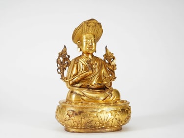A GILT COPPER 'LAMA' FIGURE