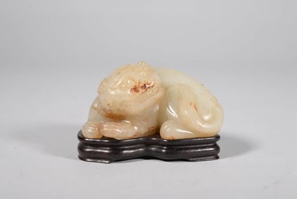 A HETIAN JADE 'AUSPICIOUS BEAST' ORNAMENT