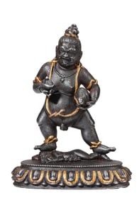 A TIBETAN IRON-CUT AND GOLD-INLAID 'BLACK WEALTH GOD' FIGURE