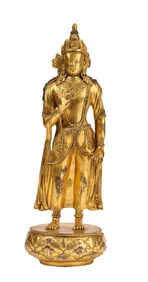 A GILT-BRONZE STANDING FIGURE OF BUDDHA