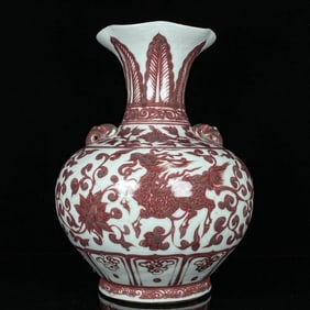 A UNDERGLAZED RED 'INTERLOCKING FLOWERS, QILIN AND PHOENIX' VASE