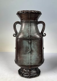 AN ANTIQUE COPPER DOUBLE-HANDLED BAMBOO-WEAVE IMITATION VASE