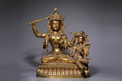 A GILT-DECORATED-BRONZE FIGURE OF FOUR-ARMED MANJUSHRI IN UNION