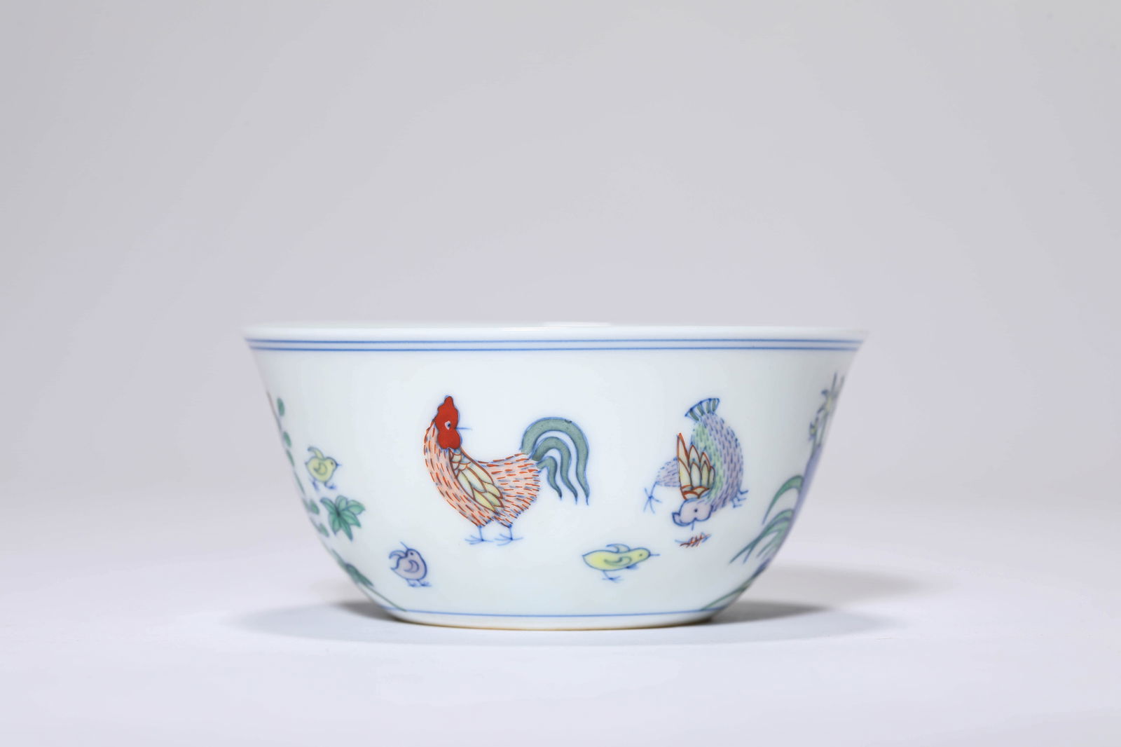 A DOUCAI 'CHICKEN' CUP: A DOUCAI 'CHICKEN' CUP Dimensions: Width: 8.4 cm (3.31 in.), Height: 3.7 cm (1.46 in.). All measurements are approximate.