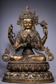 A GILT-DECORATED-BRONZE SEATED FIGURE OF FOUR-ARMED AVALOKITESHVARA