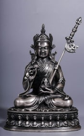 A SILVERED-BRONZE FIGURE OF PADMASAMBHAVA
