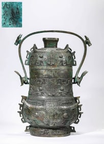 A BRONZE 'ANIMAL-MASK' YOU