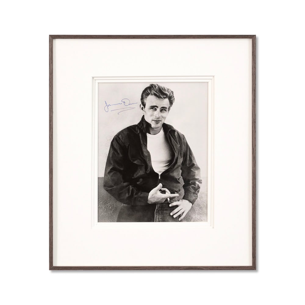 JAMES DEAN SIGNED PHOTOGRAPH: Image Dimensions: 9 3/4 x 7 5/8 in (24.6 x 19.4 cm) Framed Dimensions: 16 1/2 x 14 3/8 in (41.8 x 36.4 cm) Provenance and Authentication: This collectible has undergone a rigorous forensic