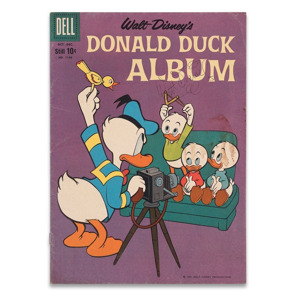 WALT DISNEY SIGNED "DONALD DUCK ALBUM" NO. 1140: 10 1/4 x 7 1/4 in (26 x 18.5 cm) Provenance and Authentication: This collectible has undergone a rigorous forensic evaluation. The signatures were carefully analyzed across multiple criteria, includin