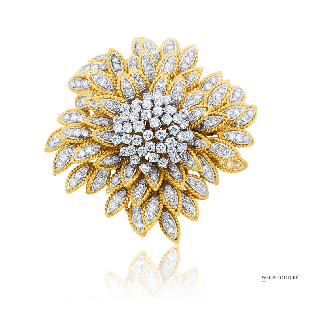 DIAMOND FLORAL BROOCH: DIAMOND FLORAL BROOCH Description: A yellow and white metal floral brooch set with white stones in layered petal formation. The images show the brooch from top and side views.