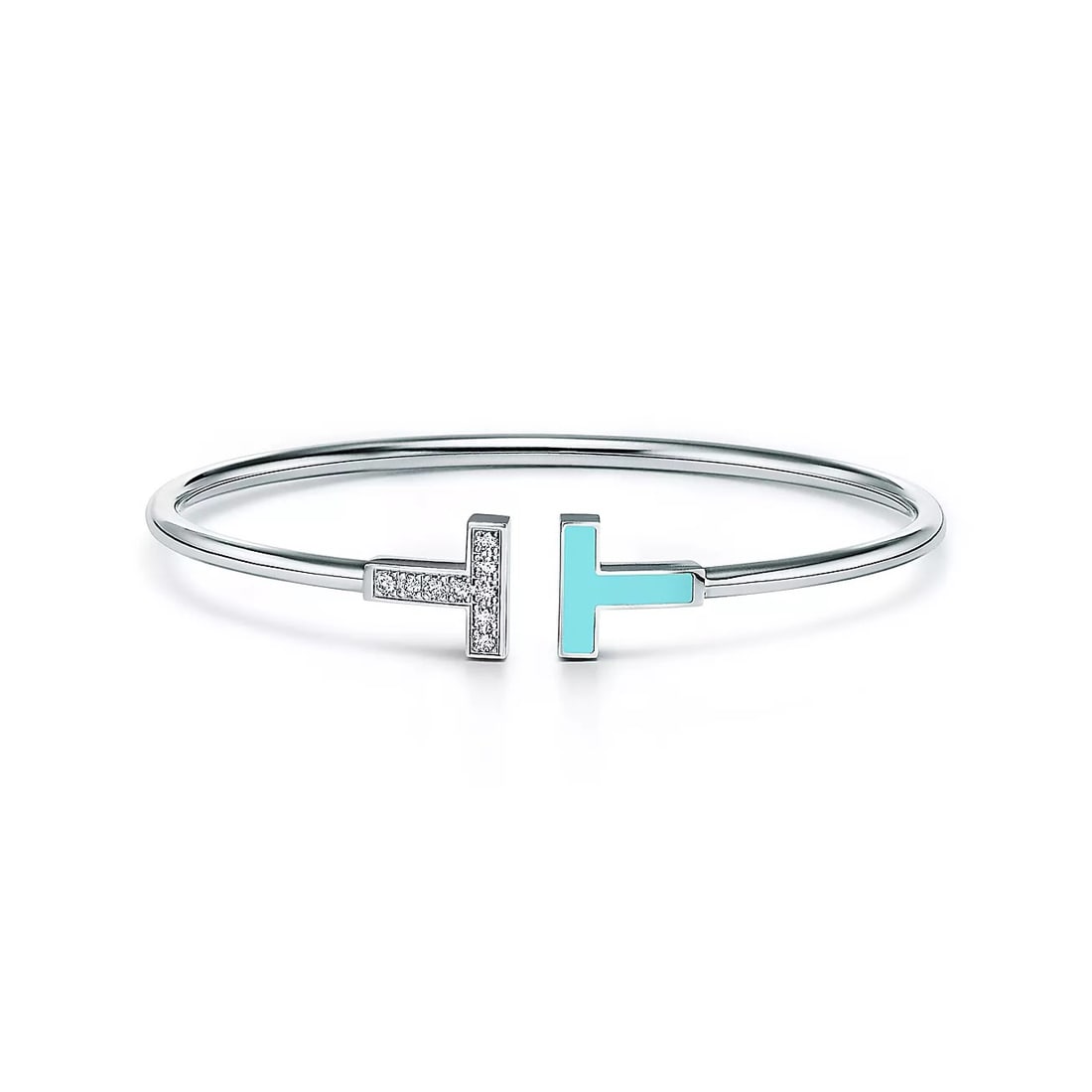 TIFFANY-STYLE T MOTIF DIAMOND AND TURQUOISE ENAMEL BANGLE: TIFFANY-STYLE T MOTIF DIAMOND AND TURQUOISE ENAMEL BANGLE Description: The lot consists of a slender open bangle bracelet crafted in white metal and designed with the iconic "T" motif at the center; o