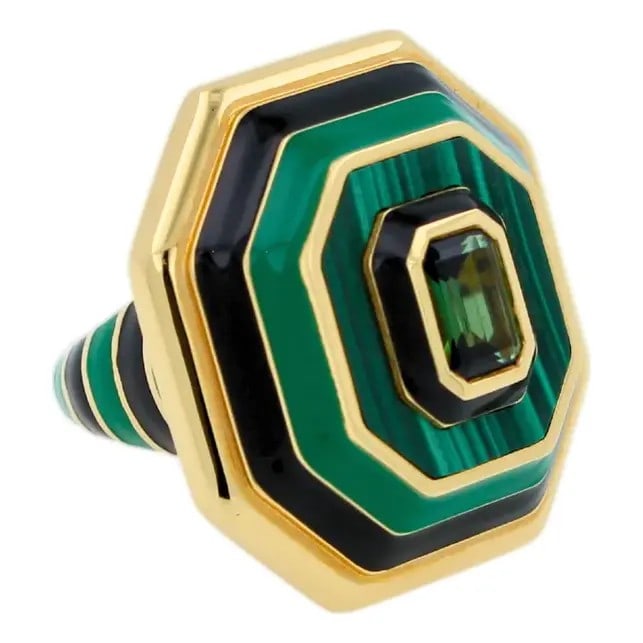 ART DECO STYLE GOLD RING WITH MALACHITE, BLACK ENAMEL, AND GREEN TOURMALINE: ART DECO STYLE GOLD RING WITH MALACHITE, BLACK ENAMEL, AND GREEN TOURMALINE Description: The ring is designed with a striking octagonal plaque top composed of layered concentric borders. The outermost