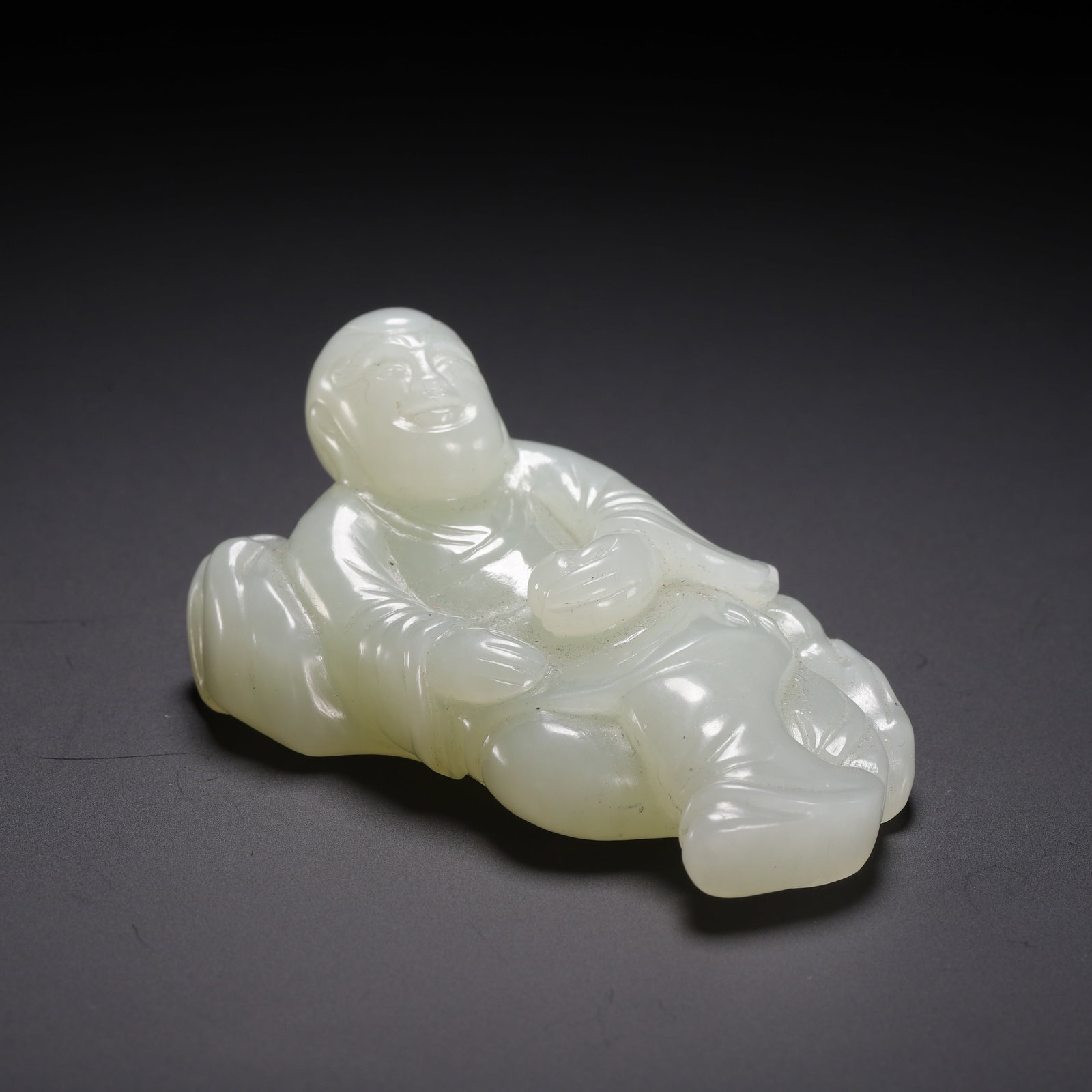 A HETIAN JADE FIGURE: A HETIAN JADE FIGURE Dimensions: Dimensions: Length: 7 cm (2.76 in.), Width: 4.2 cm (1.65 in.), Height: 3 cm (1.18 in.). Weight: 100 g. All measurements are approximate.