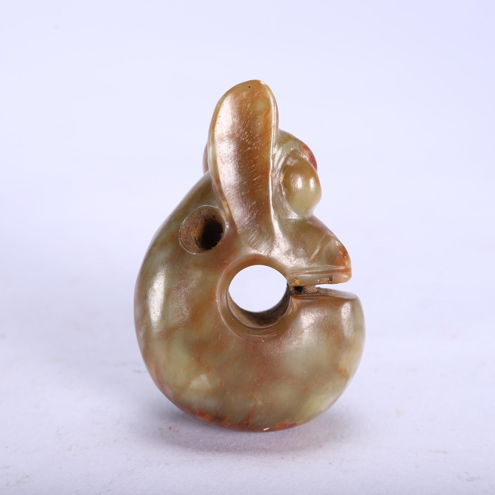 AN ARCHAIC JADE PENDANT: AN ARCHAIC JADE PENDANT Dimensions: Dimensions: Length: 4 cm (1.57 in.), Width: 2.5 cm (0.98 in.), Height: 6 cm (2.36 in.). Weight: 90 g. All measurements are approximate.