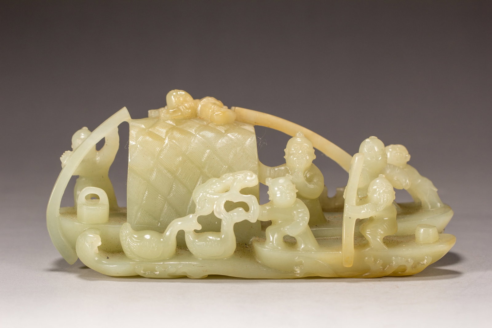 A HETIAN JADE 'FISHING BOY' ORNAMENT: A HETIAN JADE 'FISHING BOY' ORNAMENT Dimensions: Dimensions: Length: 15 cm (5.91 in.), Width: 6 cm (2.36 in.), Height: 5.5 cm (2.17 in.). Weight: 480 g. All measurements are approximate.