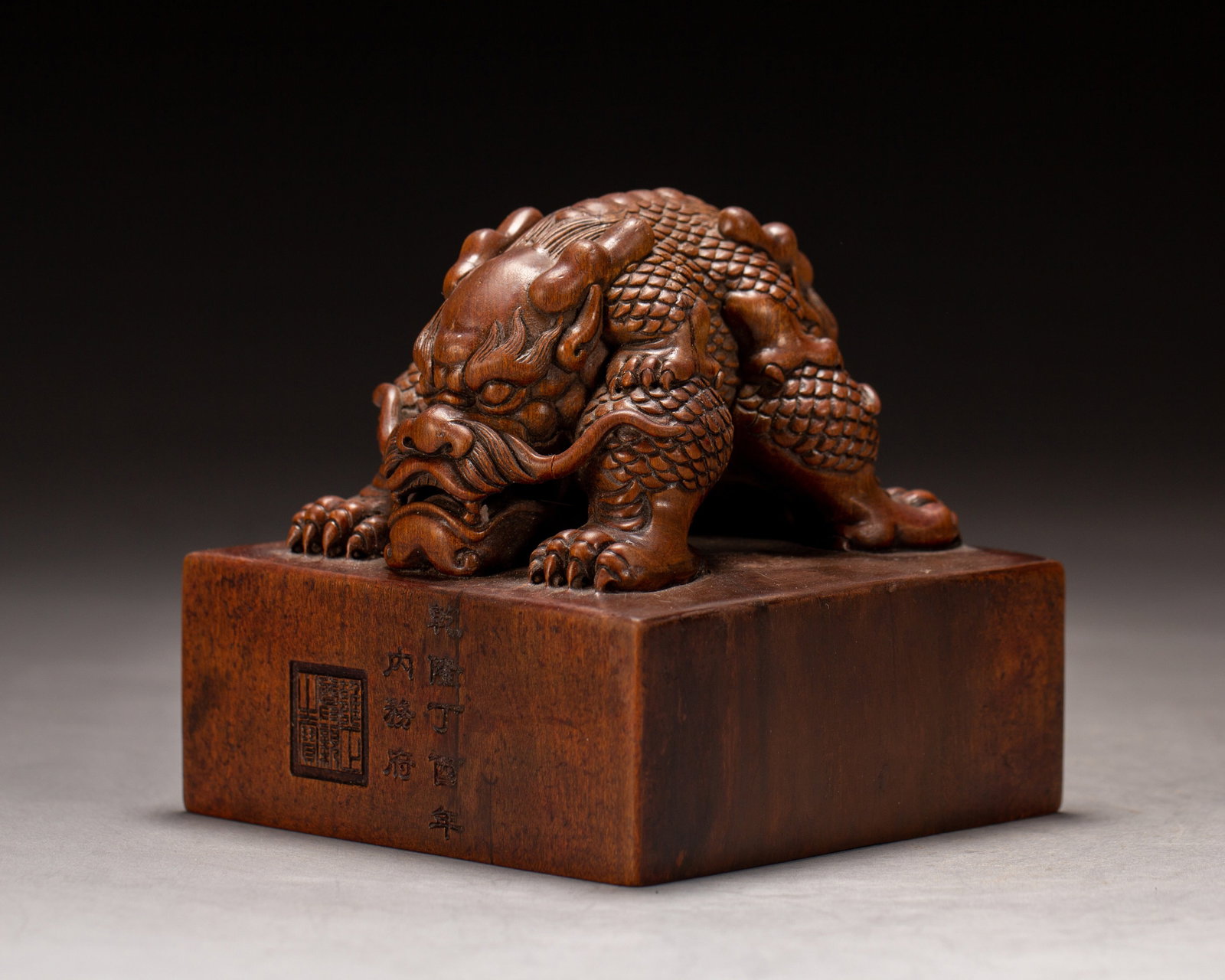 A SANDALWOOD SEAL: A SANDALWOOD SEAL Dimensions: Dimensions: Length: 8 cm (3.15 in.), Width: 8 cm (3.15 in.), Height: 7.8 cm (3.07 in.). Weight: 280 g. All measurements are approximate.