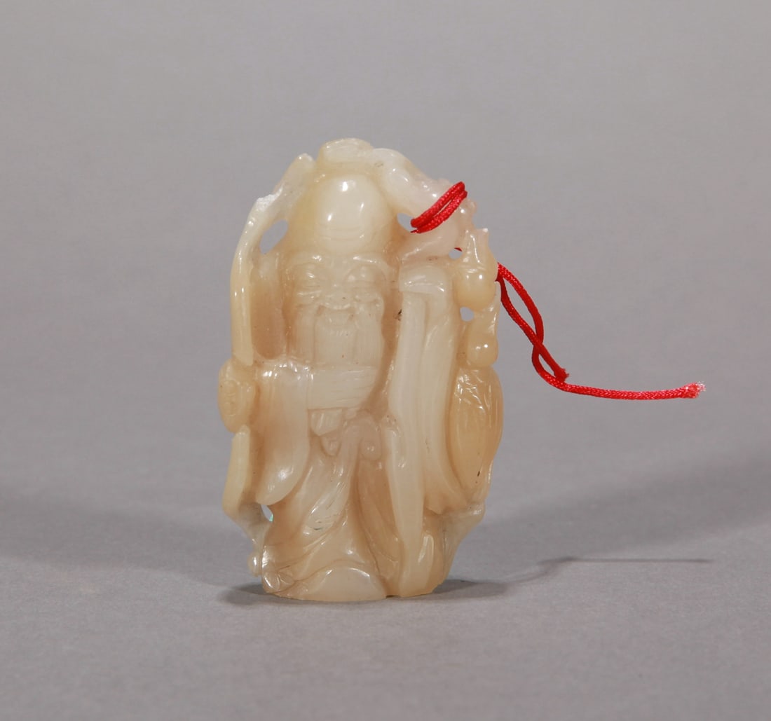 A WHITE JADE 'SHOU XING' HANDLE ORNAMENT (1 of 4)