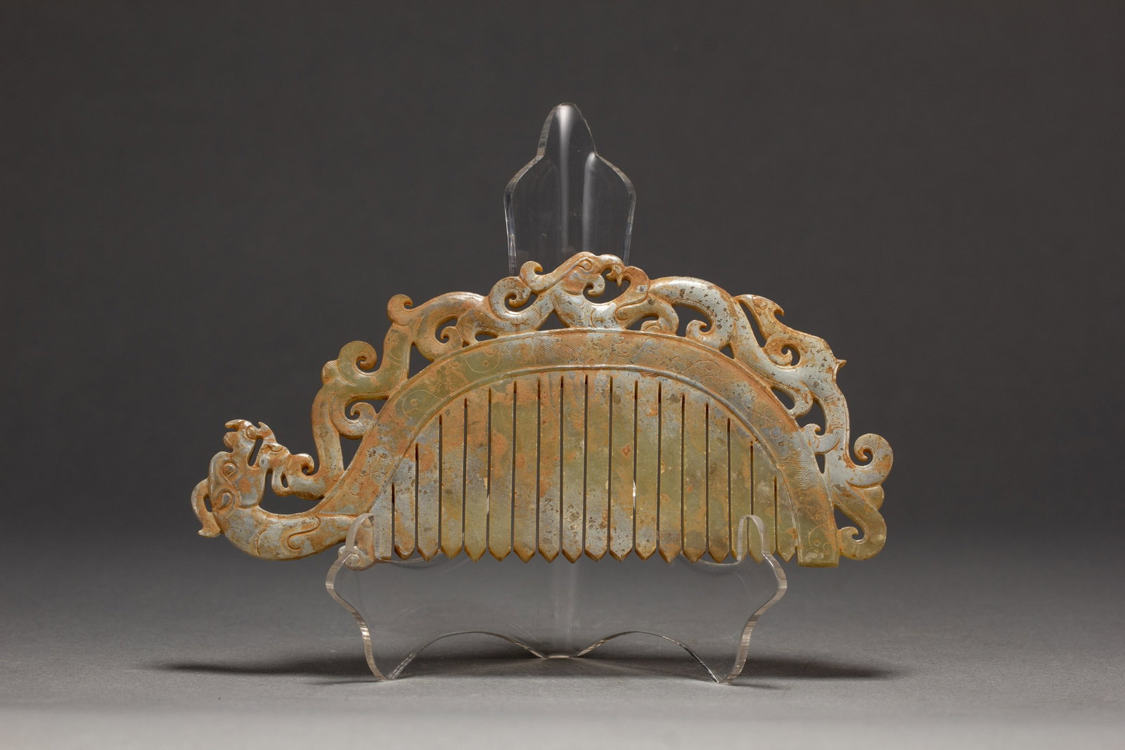 AN ARCHAIC JADE COMB: AN ARCHAIC JADE COMB Dimensions: Dimensions: Length: 14.5 cm (5.71 in.), Width: 6.8 cm (2.68 in.). Weight: 80 g. All measurements are approximate.