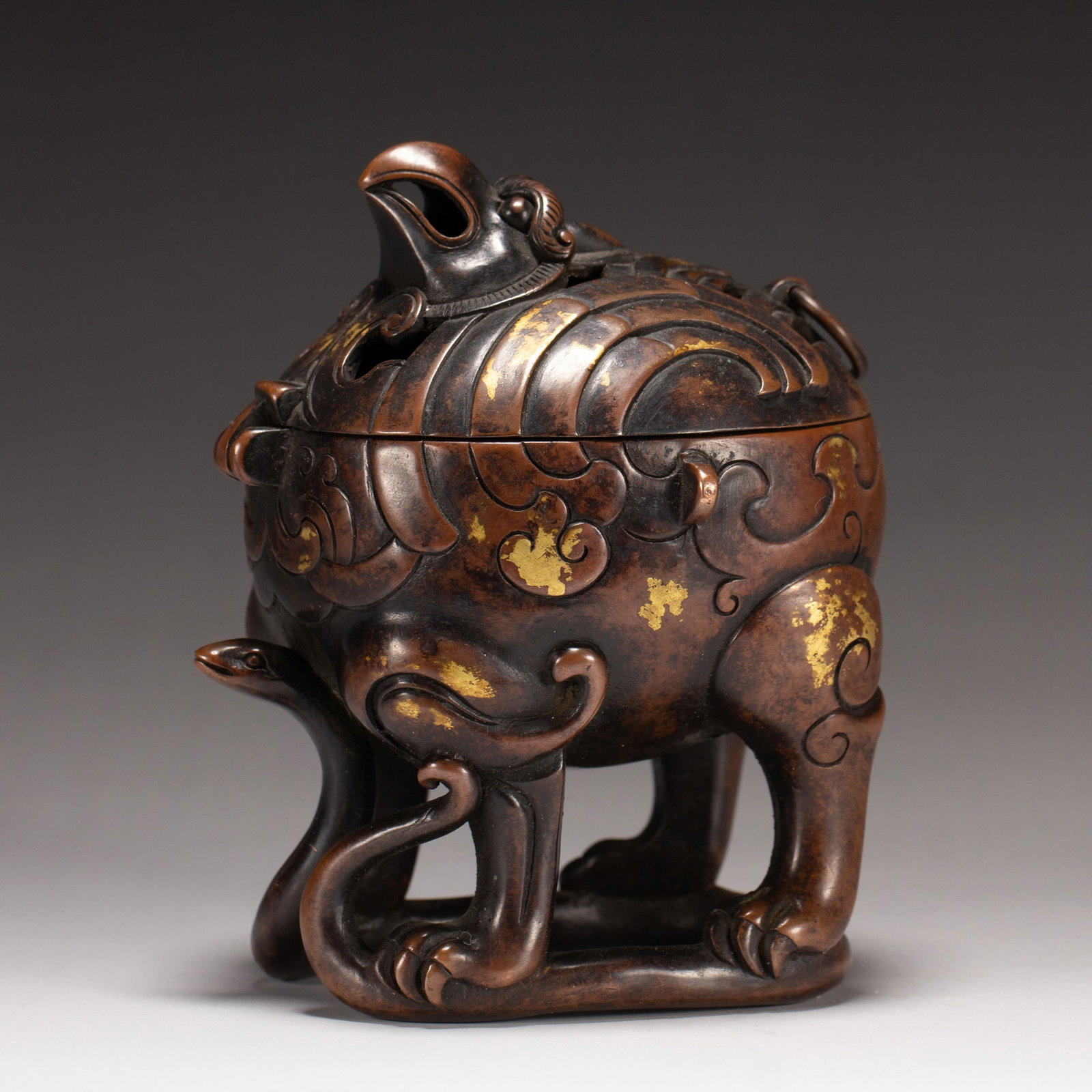 A BRONZE BEAST-FORM CENSER: A BRONZE BEAST-FORM CENSER Dimensions: Dimensions: Length: 9 cm (3.54 in.), Width: 8 cm (3.15 in.), Height: 10 cm (3.94 in.). Weight: 880 g. All measurements are approximate.