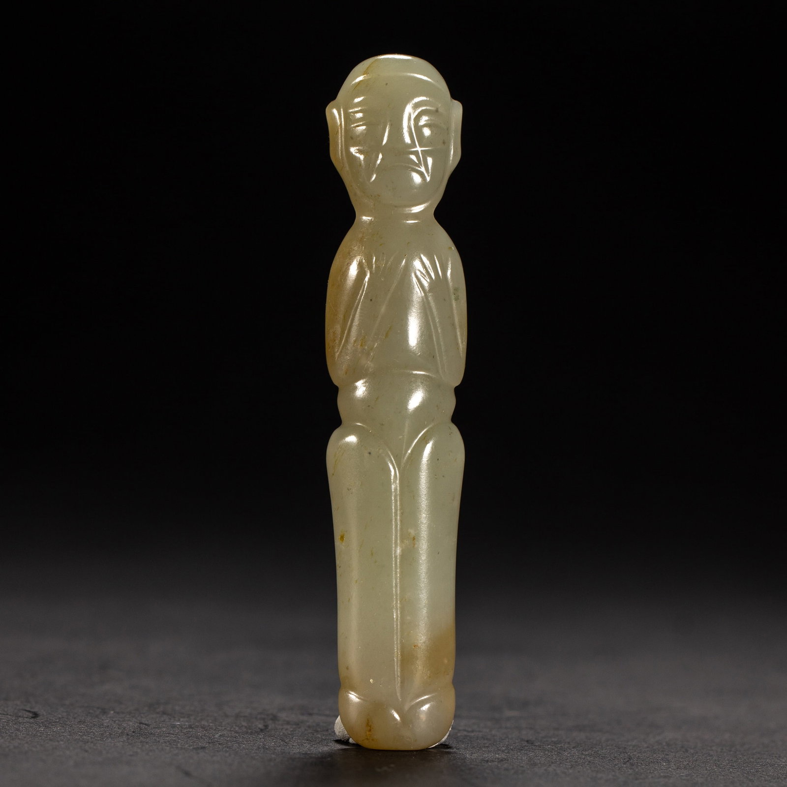 A HETIAN JADE FIGURE: A HETIAN JADE FIGURE Dimensions: Dimensions: Width: 2 cm (0.79 in.), Height: 10 cm (3.94 in.). Weight: 40 g. All measurements are approximate.