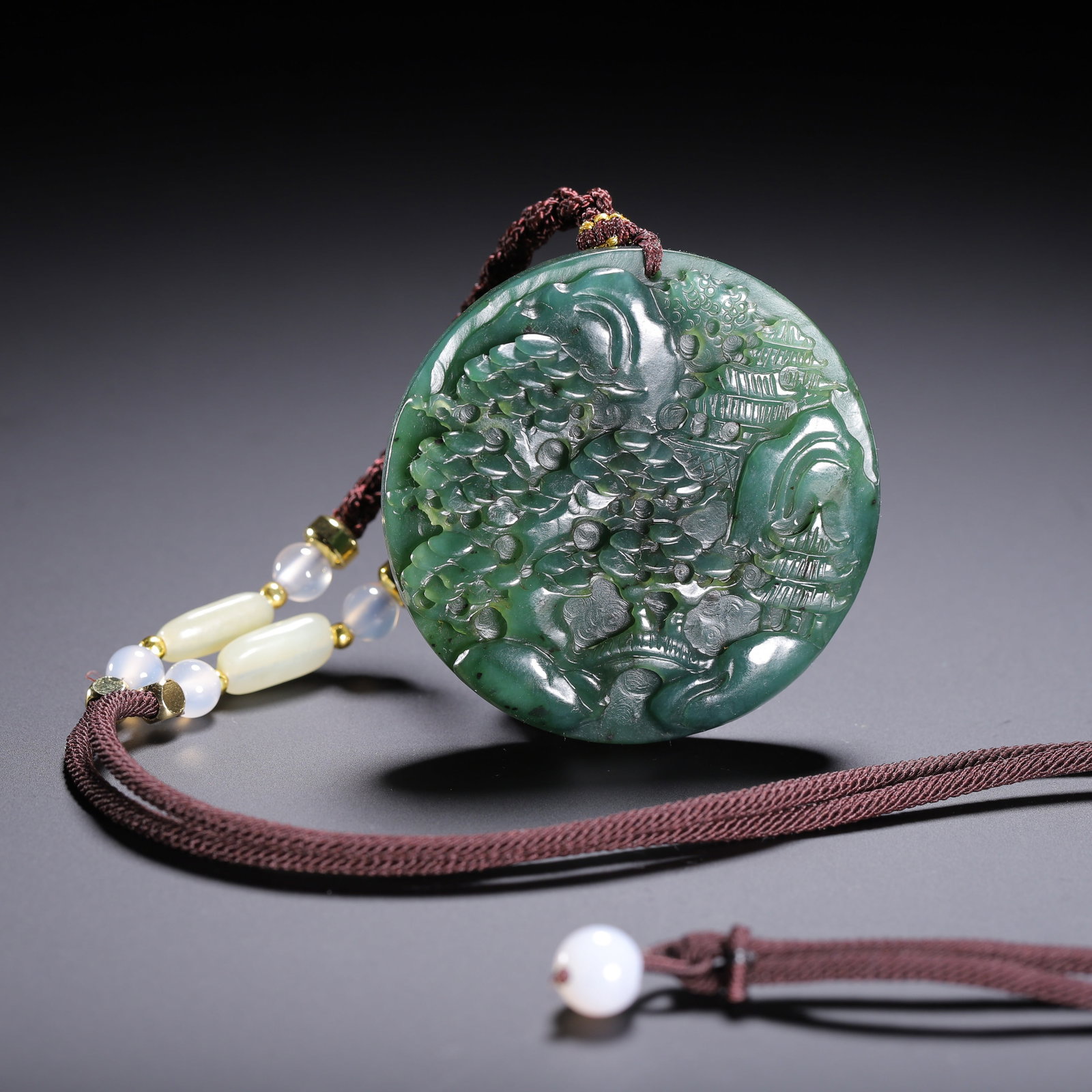 A SPINACH JADE PENDANT: A SPINACH JADE PENDANT Dimensions: Length: 5.3 cm (2.09 in.). Weight: 50 g. All measurements are approximate.