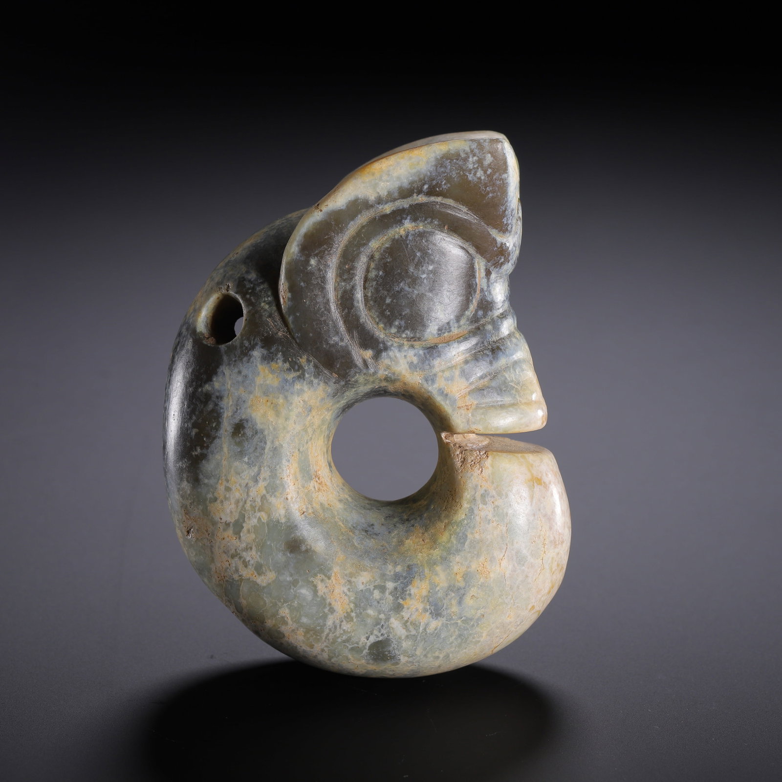 AN ARCHAIC JADE PIG-DRAGON: AN ARCHAIC JADE PIG-DRAGON Dimensions: Dimensions: Length: 6.7 cm (2.64 in.), Width: 3.5 cm (1.38 in.), Height: 9.2 cm (3.62 in.). Weight: 320 g. All measurements are approximate.