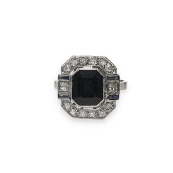 ART DECO RING SAPPHIRES AND DIAMONDS: ART DECO RING SAPPHIRES AND DIAMONDS Description: Art deco ring, highlighting a central sapphire octagonal shape of 3 carats, with a deep blue tint. This one is enhanced by an entourage of 14 8X8 cut 