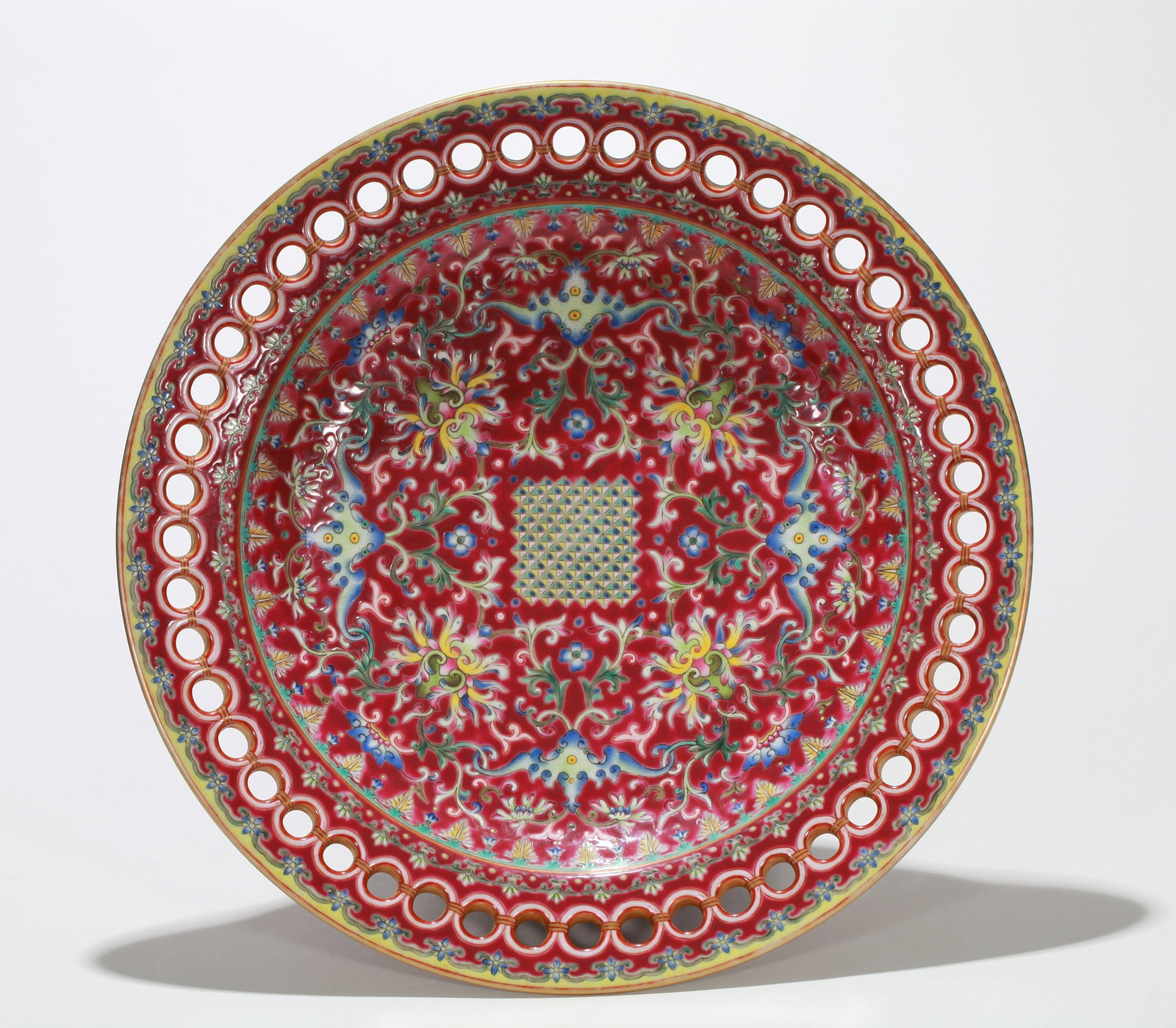 A RUBY-GROUND 'INTERLOCKING FLOWERS' LARGE OPENWORK DISH: A RUBY-GROUND 'INTERLOCKING FLOWERS' LARGE OPENWORK DISH Dimensions: Length: 38.5 cm (15.16 in.), Width: 38.5 cm (15.16 in.). All measurements are approximate.