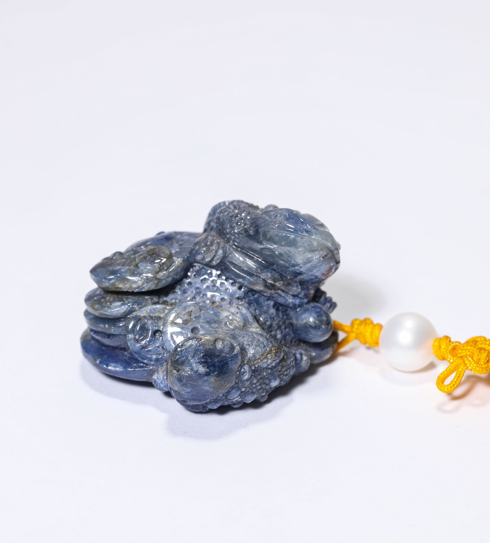 A SAPPHIRE CARVED GOLDEN TOAD: A SAPPHIRE CARVED GOLDEN TOAD Dimensions: Length: 3.8 cm (1.50 in.), Width: 3.3 cm (1.30 in.), Height: 2.5 cm (0.98 in.). All measurements are approximate.