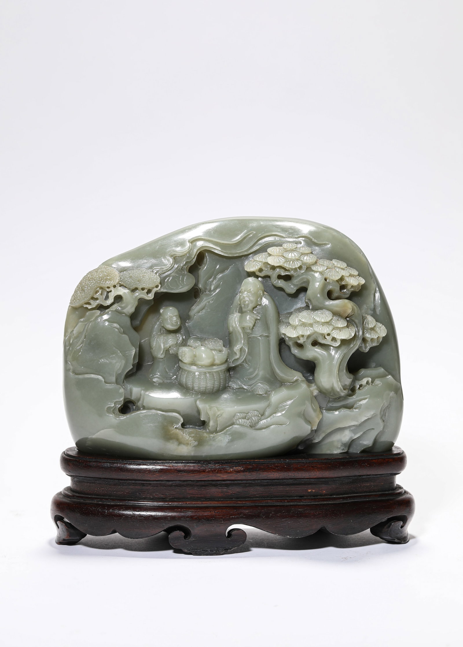 A JADE CARVED 'FIGURES AND STORY' MOUNTAIN-FORM ORNAMENT: A JADE CARVED 'FIGURES AND STORY' MOUNTAIN-FORM ORNAMENT Dimensions: Length: 18.5 cm (7.28 in.), Width: 7.3 cm (2.87 in.), Height: 13 cm (5.12 in.). All measurements are approximate.