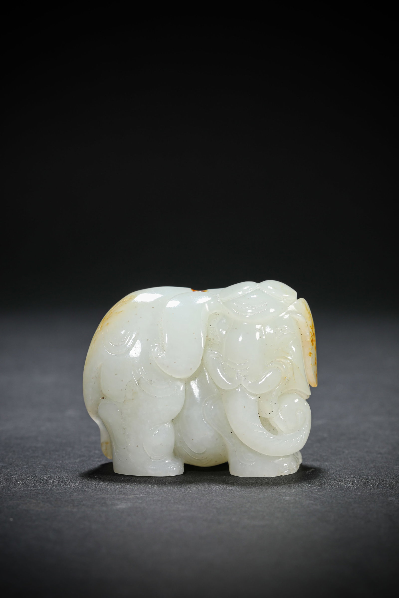 A JADE ELEPHANT: A JADE ELEPHANT Dimensions: Length: 5.7 cm (2.24 in.), Width: 2.6 cm (1.02 in.), Height: 4.6 cm (1.81 in.). All measurements are approximate.