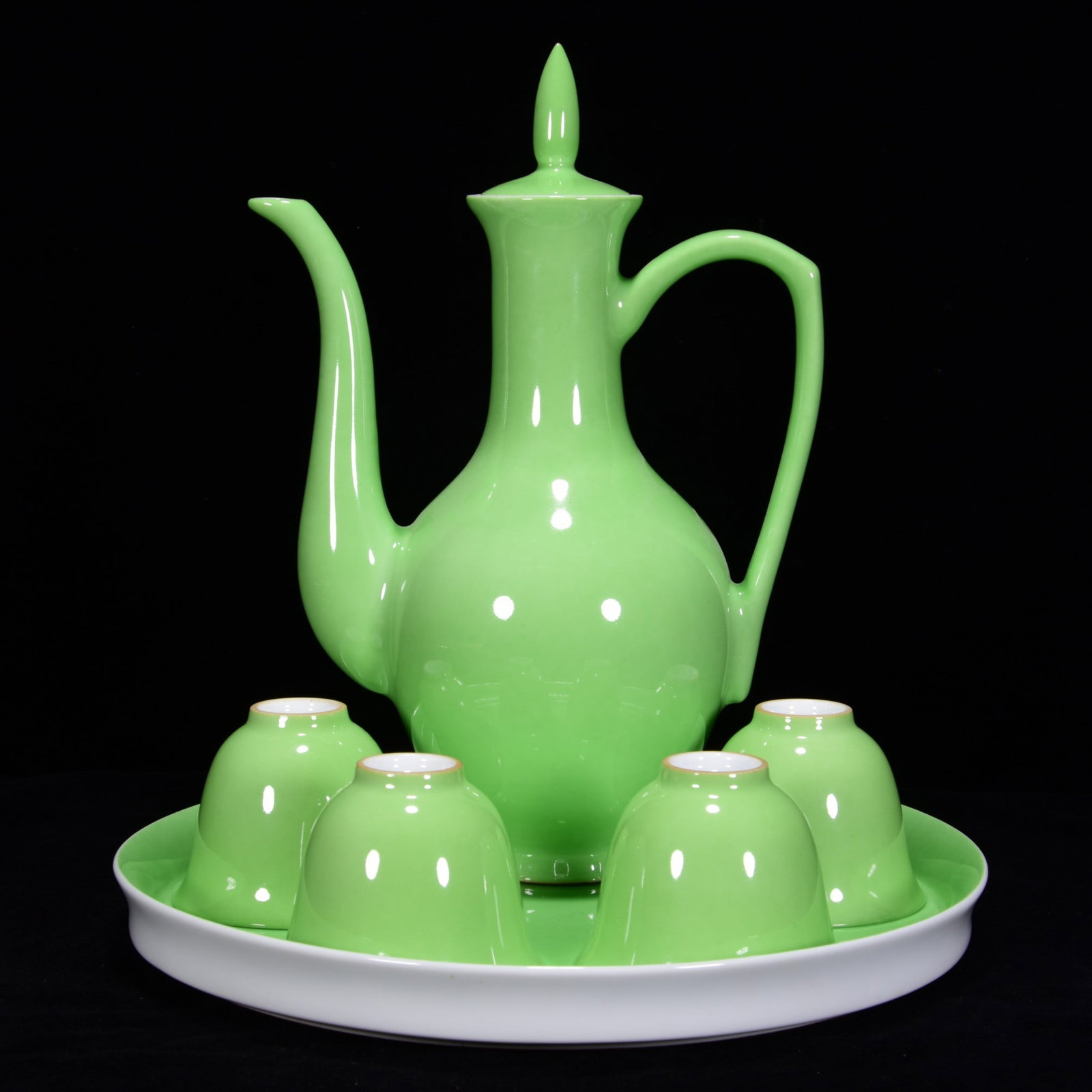 AN APPLE GREEN-GLAZED WINE SET: AN APPLE GREEN-GLAZED WINE SET Plate Dimensions: Length: 2.5 cm (0.98 in.), Width: 22 cm (8.66 in.). Teapot Dimensions: Length: 22 cm (8.66 in.), Width: 15 cm (5.91 in.). Cup Dimensions: Length: 5 cm 