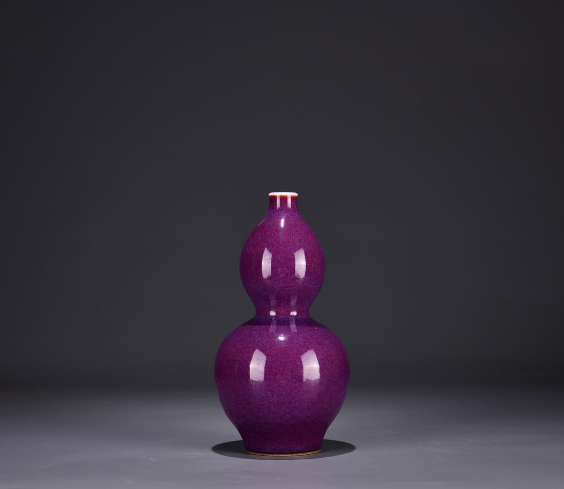 A RUBY RED-GLAZED GOURD VASE: A RUBY RED-GLAZED GOURD VASE Dimensions: Length: 22.5 cm (8.86 in.), Width: 12 cm (4.72 in.). All measurements are approximate.