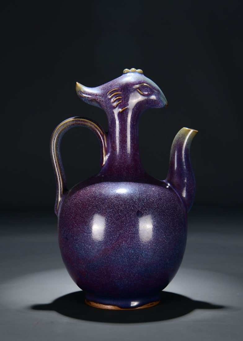 A JUN TYPE GRAPE-PURPLE GLAZED PHOENIX-HEAD EWER: A JUN TYPE GRAPE-PURPLE GLAZED PHOENIX-HEAD EWER Dimensions: Length: 27 cm (10.63 in.), Width: 17 cm (6.69 in.). All measurements are approximate.