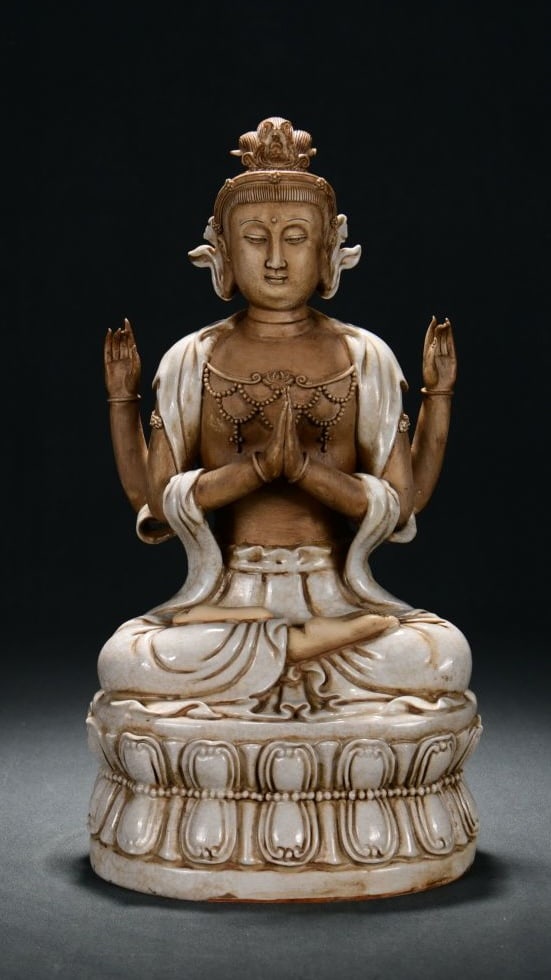 A DEHUA WHITE-GLAZED CRACKLED FOUR-ARMED GUANYIN: A DEHUA WHITE-GLAZED CRACKLED FOUR-ARMED GUANYIN Dimensions: Height: 40 cm (15.75 in.), Width: 21 cm (8.27 in.). All measurements are approximate.