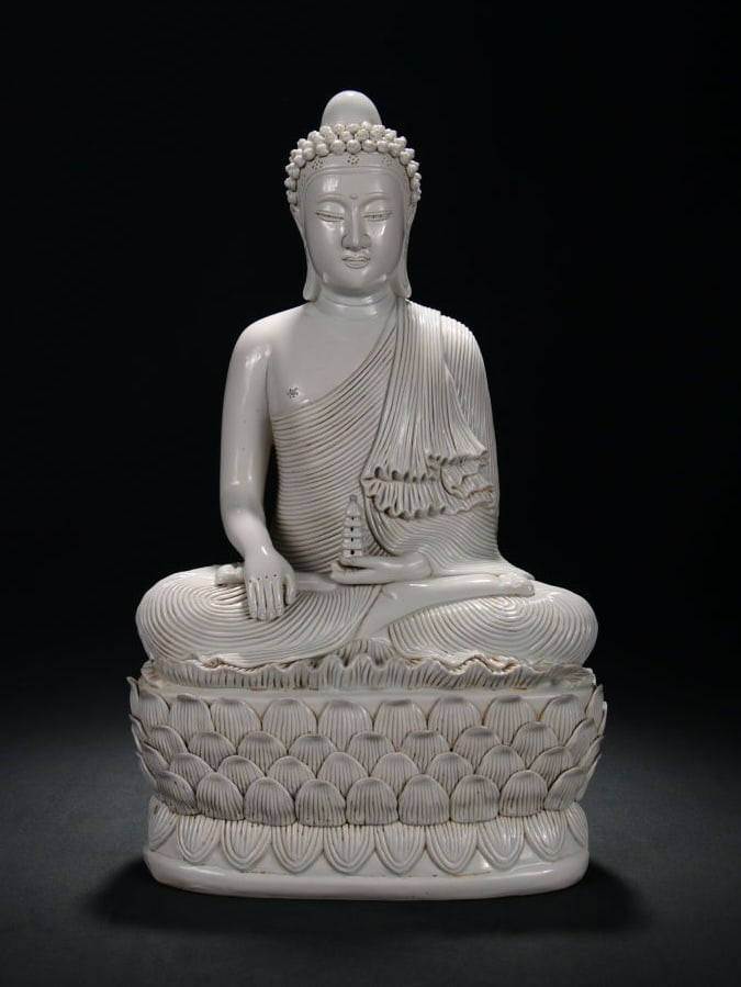 A DEHUA YINGQING GLAZED TIBETAN BUDDHA FIGURE: A DEHUA YINGQING GLAZED TIBETAN BUDDHA FIGURE Dimensions: Height: 48 cm (18.90 in.), Width: 29 cm (11.42 in.). All measurements are approximate.
