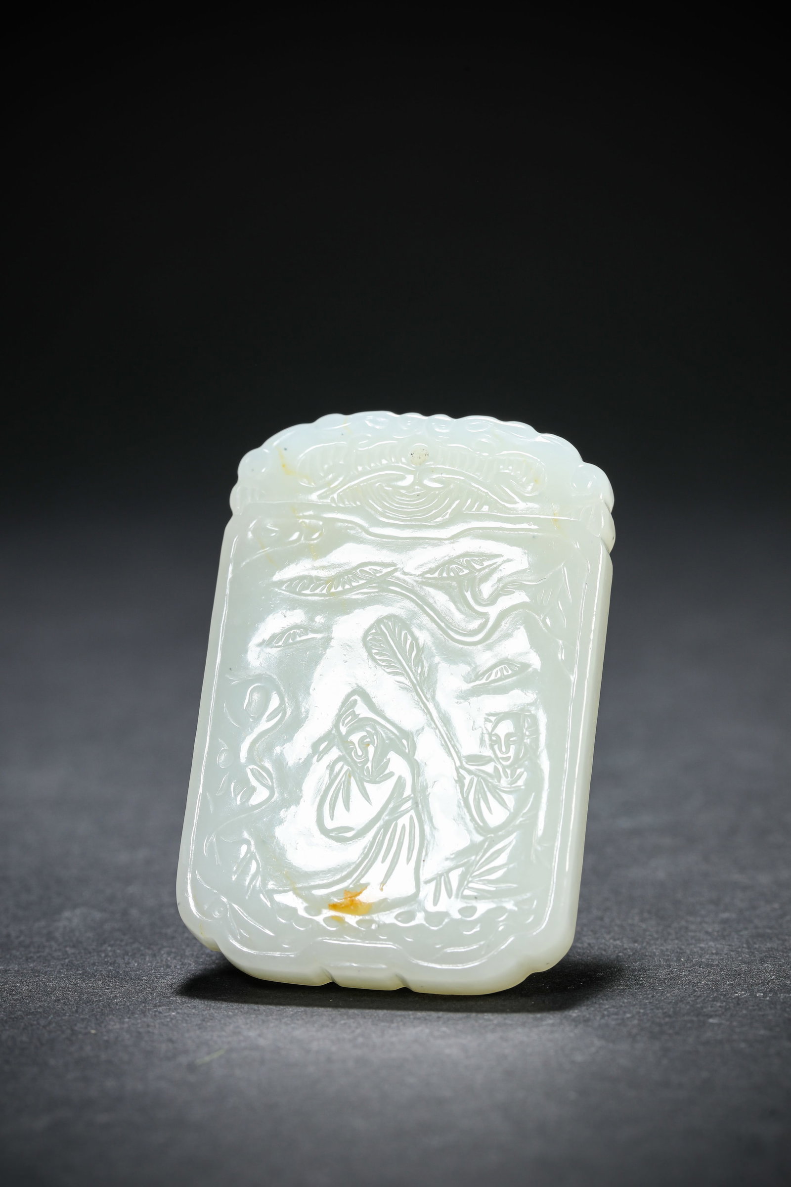 A JADE CARVED 'FIGURES AND FLOWERS' PLAQUE: A JADE CARVED 'FIGURES AND FLOWERS' PLAQUE Dimensions: Width: 3.6 cm (1.42 in.), Height: 5.3 cm (2.09 in.). All measurements are approximate.