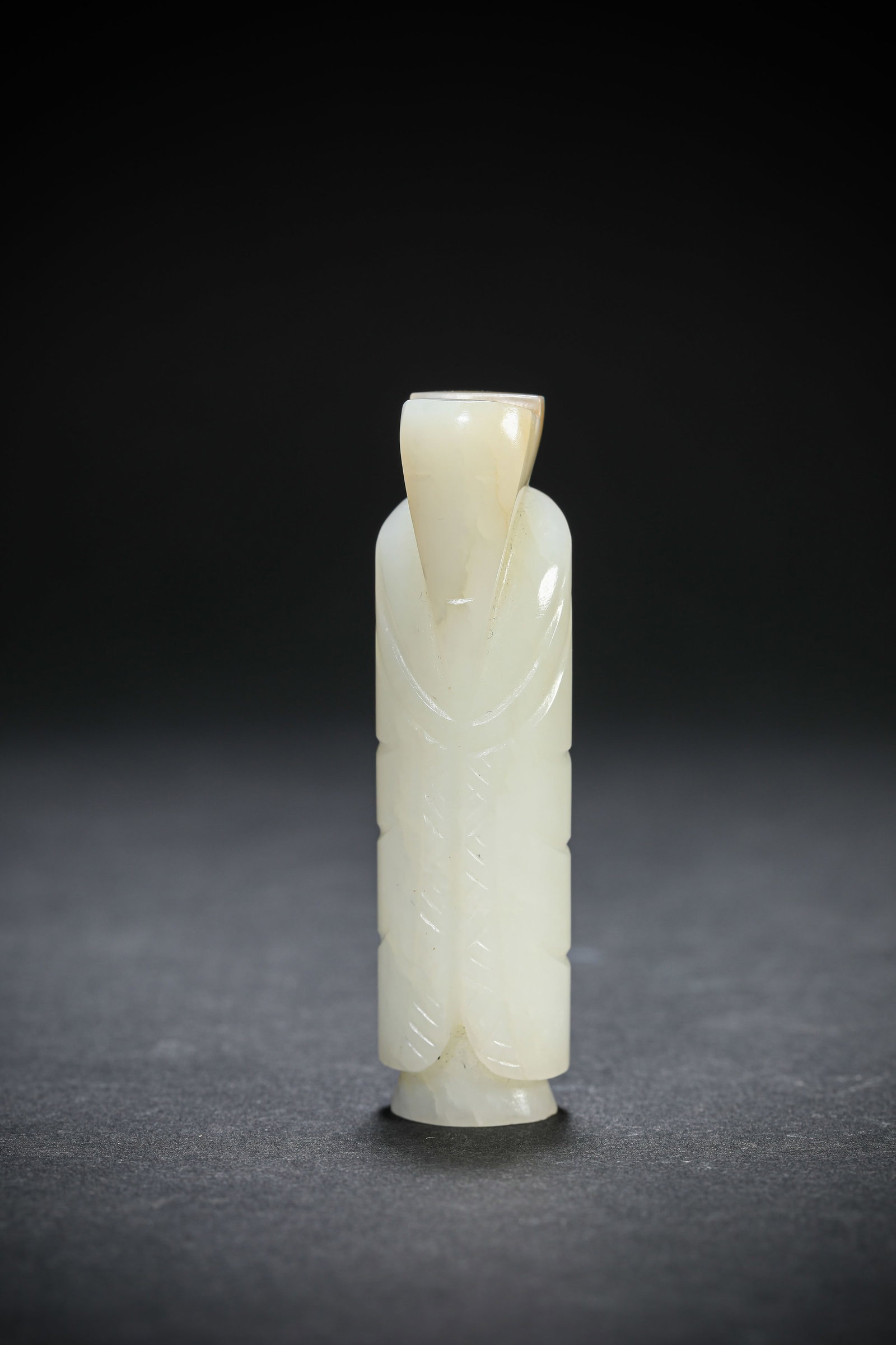 A JADE CARVED 'FIGURE' PENDANT: A JADE CARVED 'FIGURE' PENDANT Dimensions: Width: 1.8 cm (0.71 in.), Height: 6.5 cm (2.56 in.). All measurements are approximate.