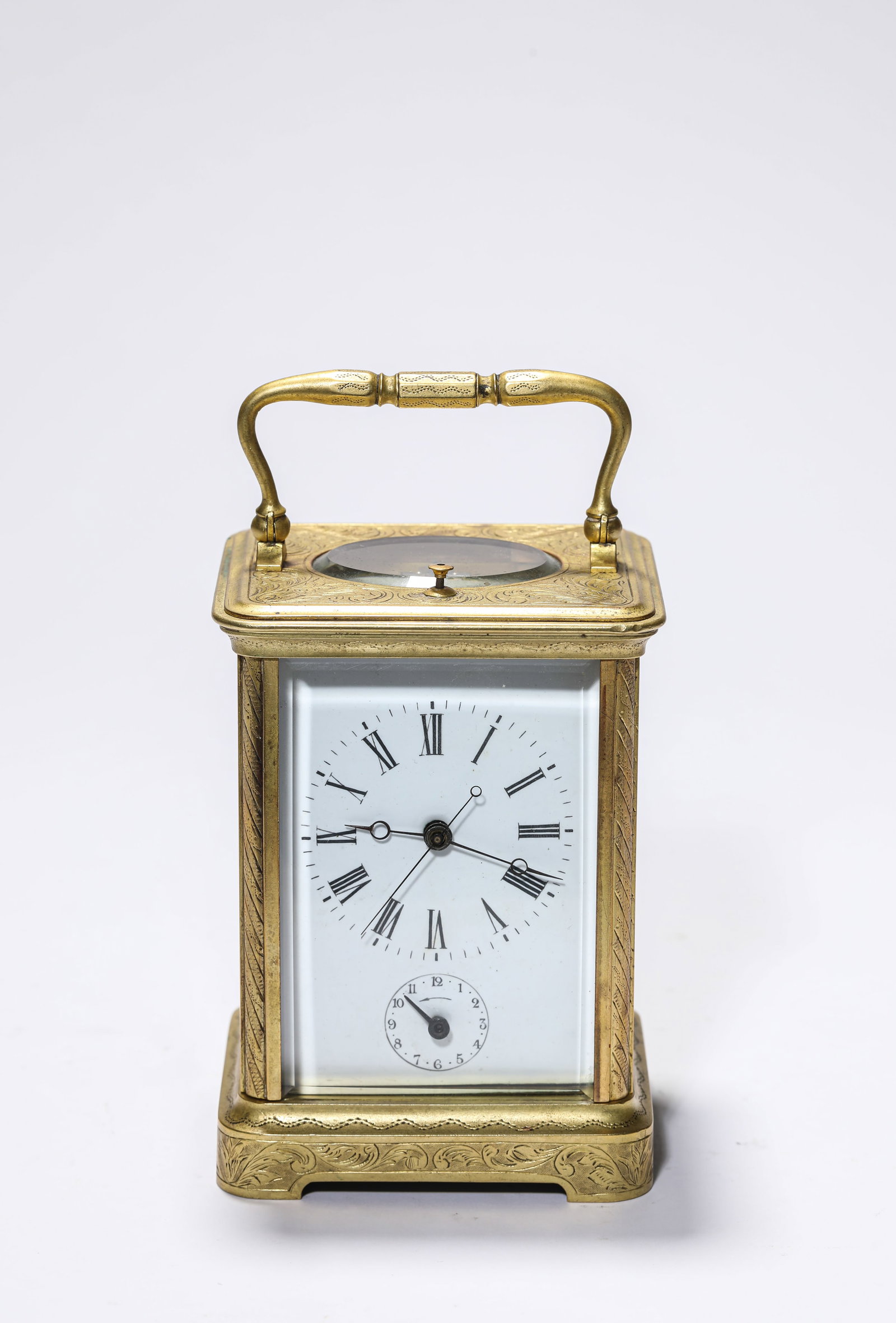 A GILT DECORATED-BRONZE CARRIAGE CLOCK: A GILT DECORATED-BRONZE CARRIAGE CLOCK Dimensions: Length: 9.6 cm (3.78 in.), Width: 8.5 cm (3.35 in.), Height: 14.8 cm (5.83 in.). Weight: 1737 g. All measurements are approximate.