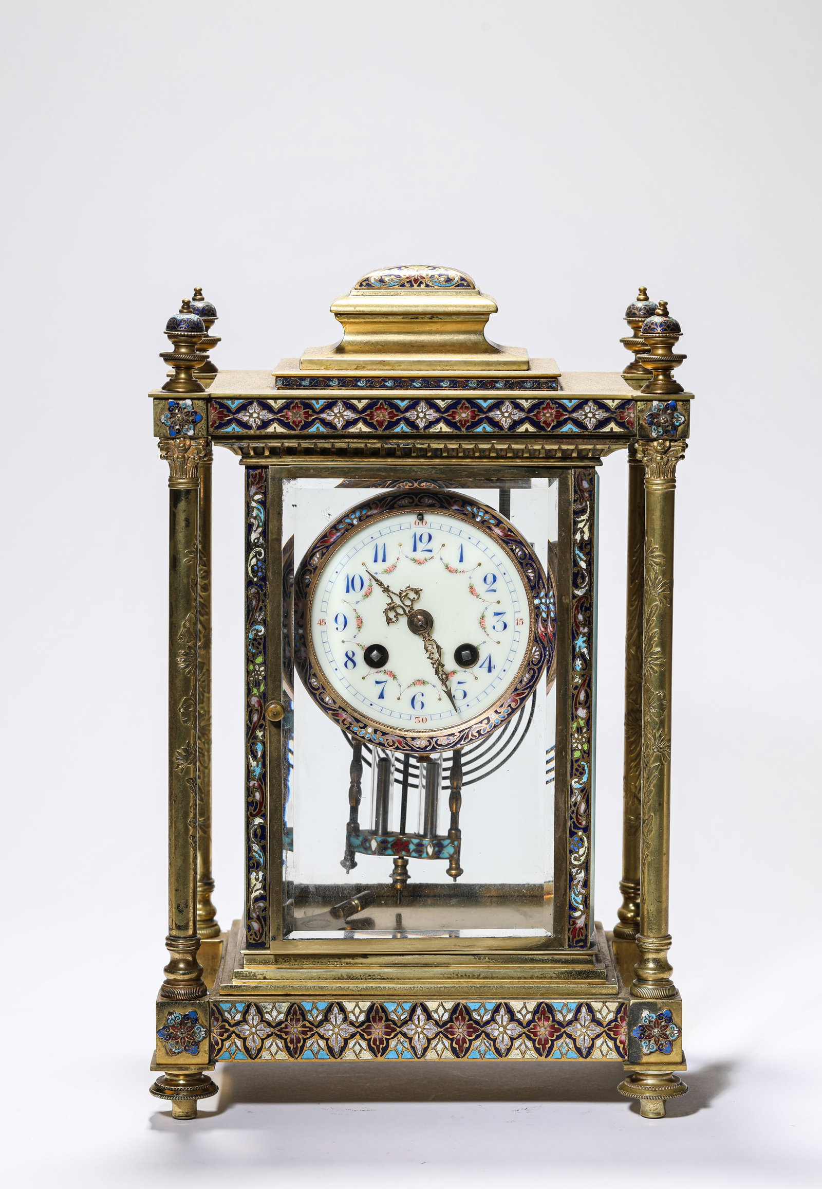 A GILT DECORATED-BRONZE AND CLOISONNE ENAMEL MANTEL CLOCK: A GILT DECORATED-BRONZE AND CLOISONNE ENAMEL MANTEL CLOCK Dimensions: Length: 22.2 cm (8.74 in.), Width: 14 cm (5.51 in.), Height: 34 cm (13.39 in.). Weight: 6.7 kg. All measurements are approximate.