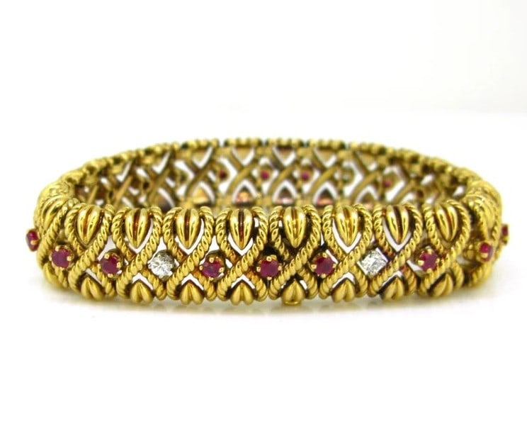 A VINTAGE RUBY: A VINTAGE RUBY Description: Using 18K gold as a base, paired with natural rubies (round cut) and diamonds (square/round cut) - the rich color of gold forms a striking contrast with the bright red of t